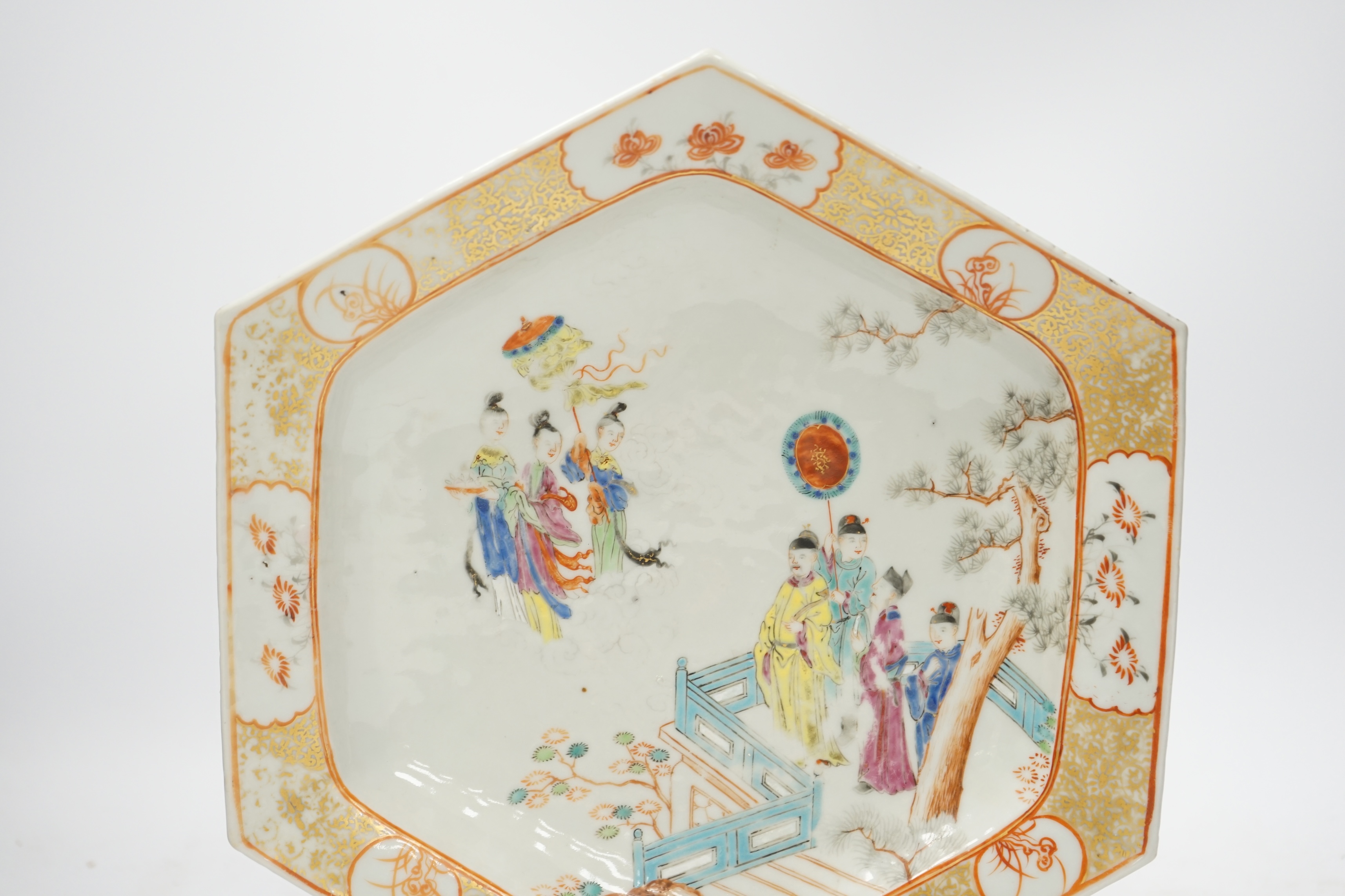 An 18th century Chinese hexagonal dish, painted with figures on a terrace, 28cm wide. Condition - fair, feint star crack to base